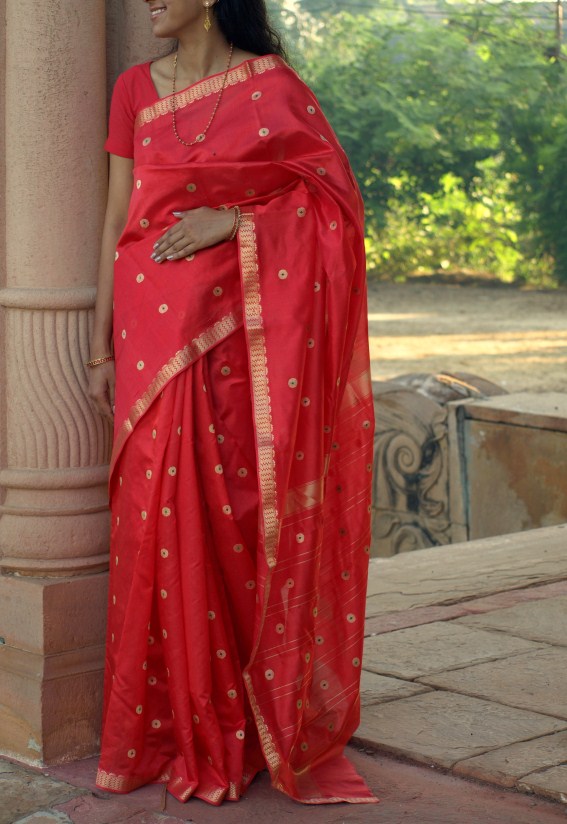 A model wearing a red Chanderi saree. Photograph courtesy and copy right Hands of India.