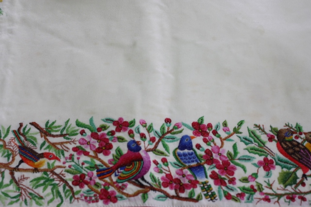 This is an antique petit-point embroidery, very English, depicting birds of paradise. The entire border has 48 different birds. 