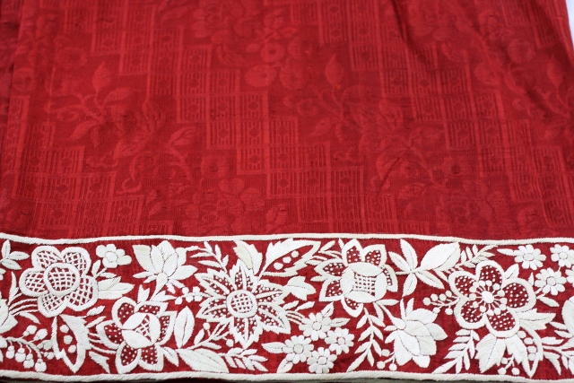 An antique kor ni saree or border saree on red crepe silk.