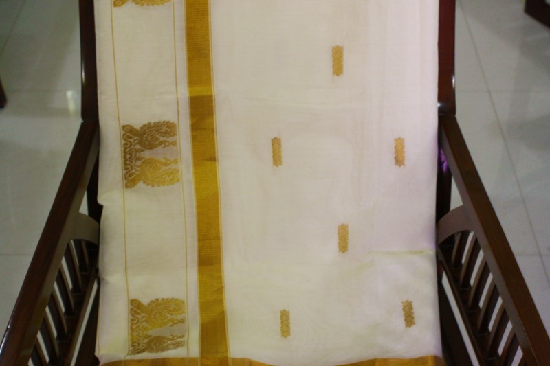 A traditionally designed pure cotton Kasavu with its yellow and shimmery gold embellishments.